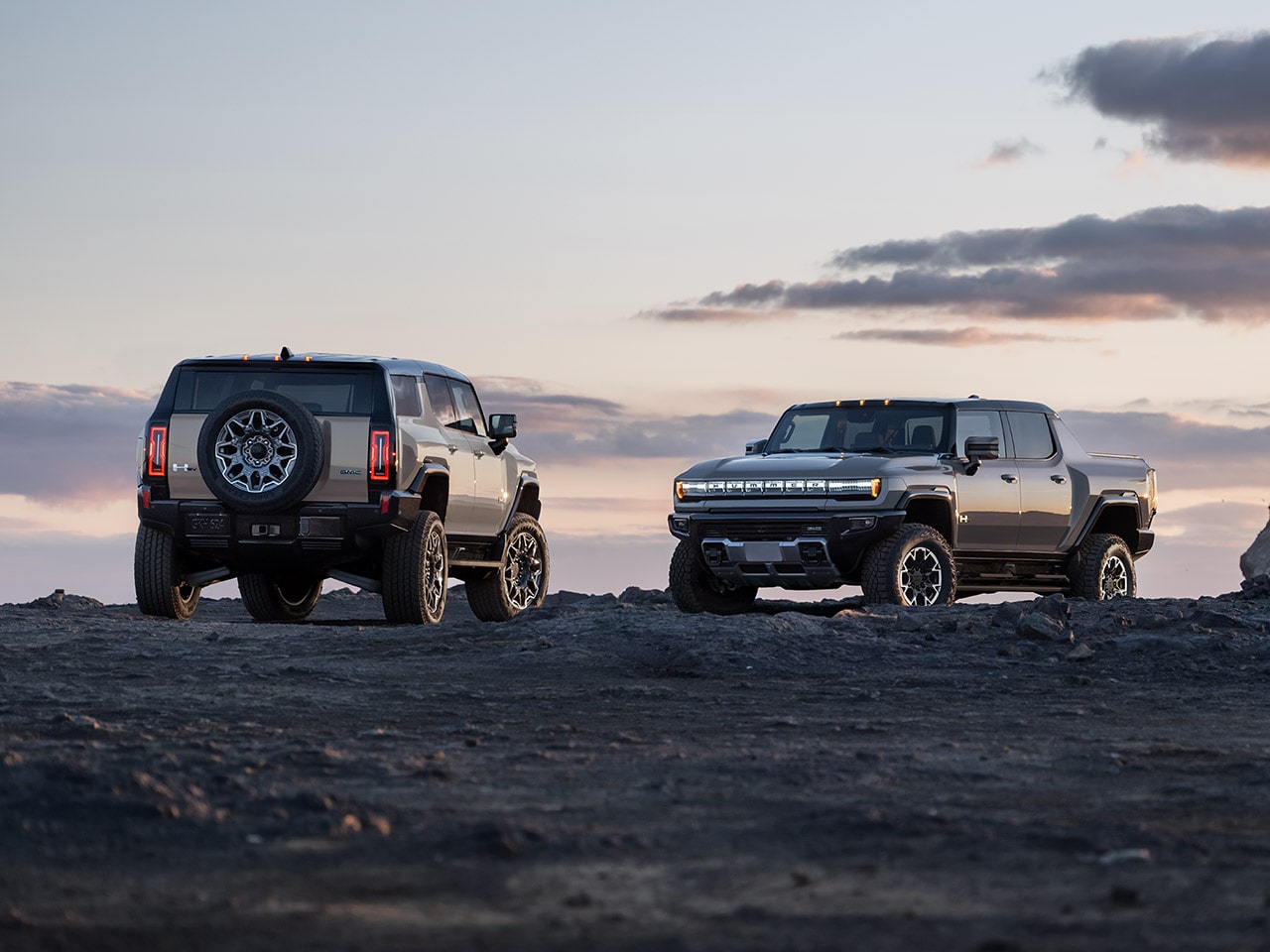 Two 2026 GMC Hummer EVs parked outdoors.