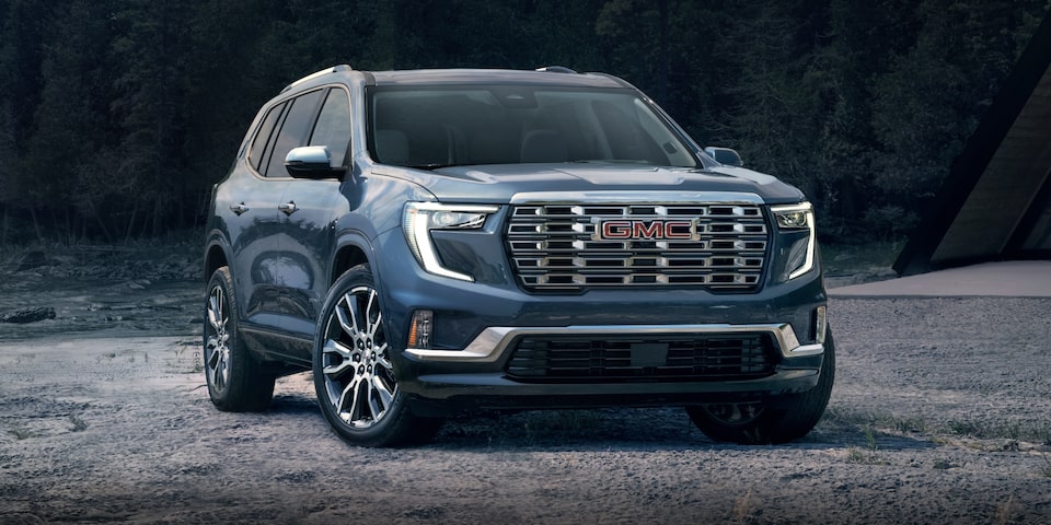 Front-side view of the 2024 GMC Acadia Denali with a unique grille and badging.