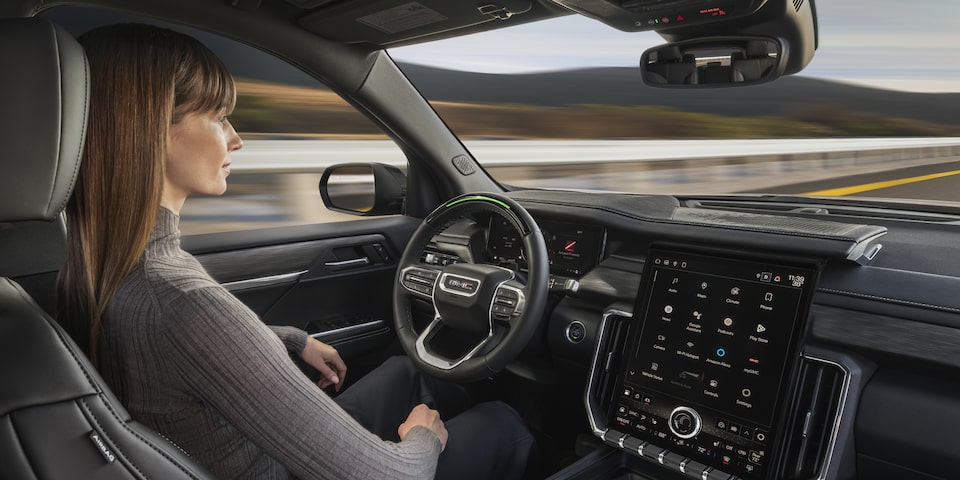 A person utilizing the Super Cruise technology on the 2025 GMC Acadia Elevation.