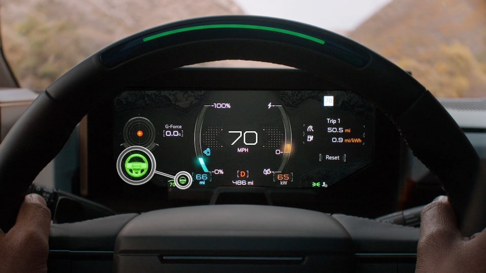 Close-up view of the Super Cruise Feature on the 2025 GMC Hummer EV Digital Cockpit with a person's hands on the steering wheel.