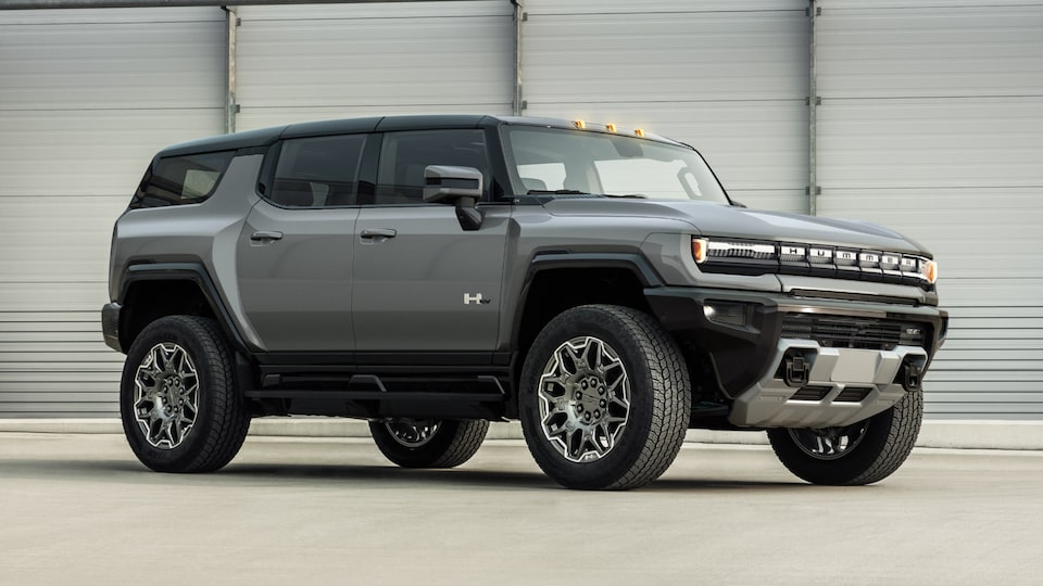 Side view of a gray 2025 GMC Hummer EV SUV.