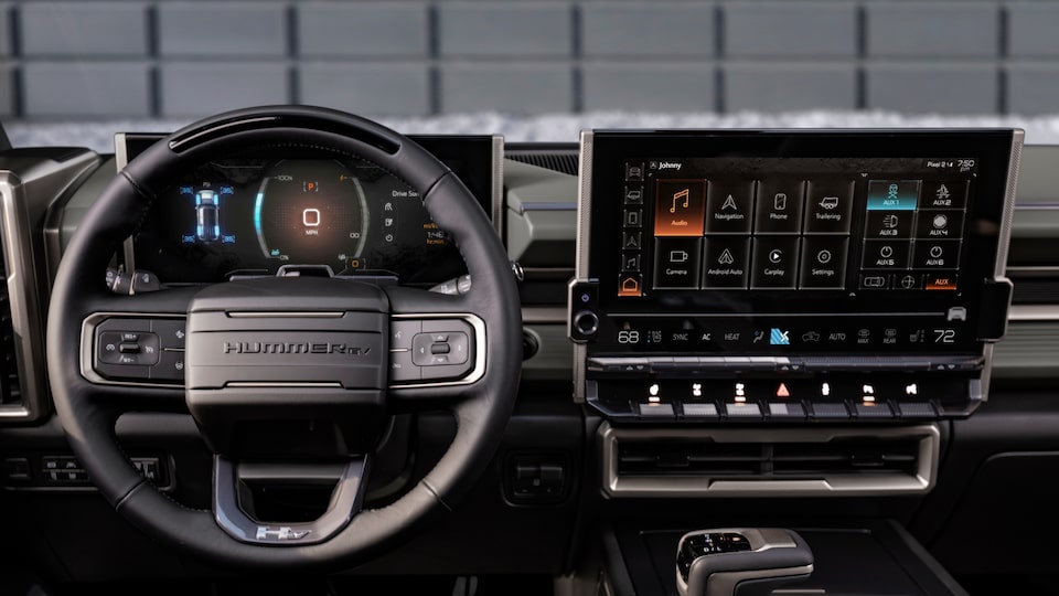 Front view of the steering wheel and infotainment screen on the 2025 GMC Hummer EV SUV.