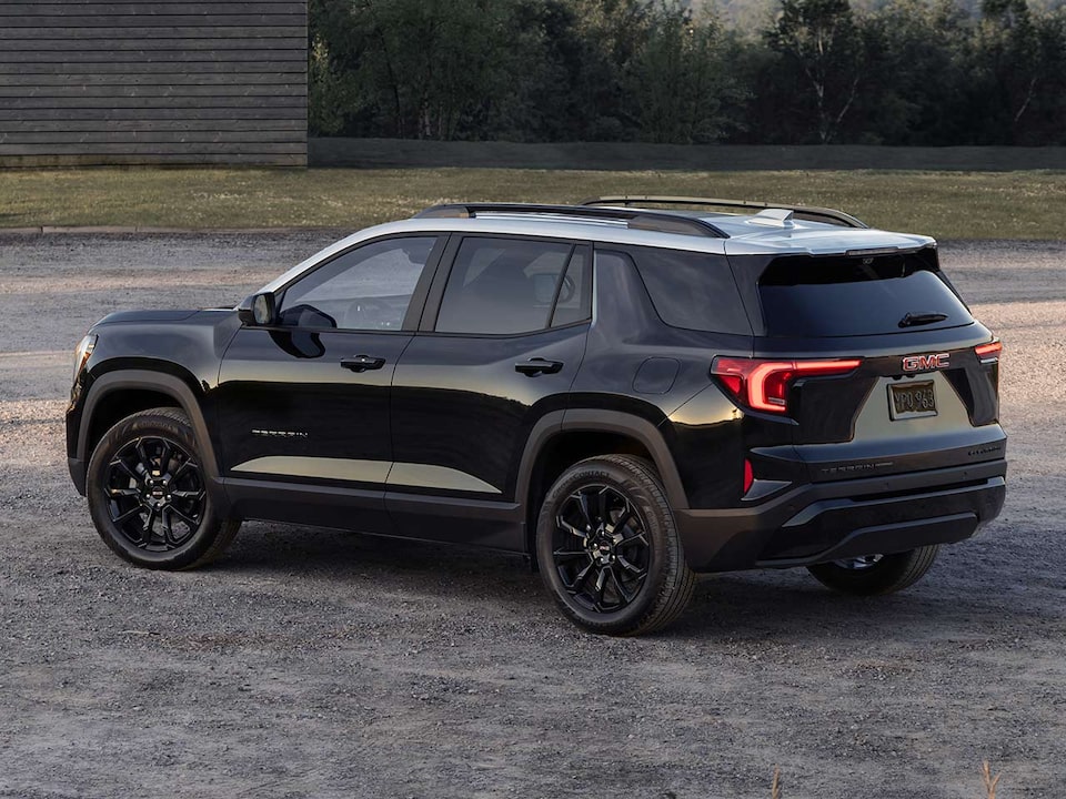 Back-side view of the 2025 GMC Terrain parked alone outdoors.