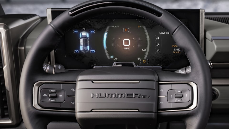 Steering wheel and dashboard of the GMC Hummer EV Pickup: Regen On Demand paddle engaged.