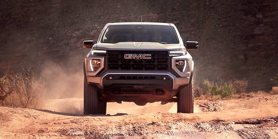 Front view of the 2025 GMC Canyon off-roading in the desert.