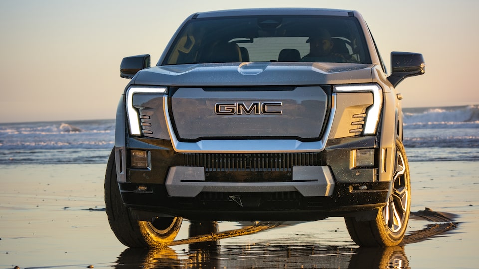 Front view of the 2025 GMC Sierra EV Denali parked by the beach.