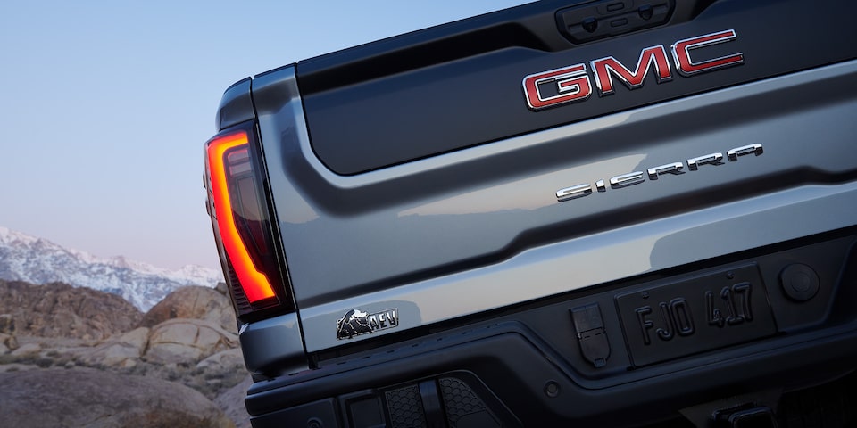 Close-up view of the "AEV" badging on the back of a 2025 GMC Sierra HD AT4X AEV truck.