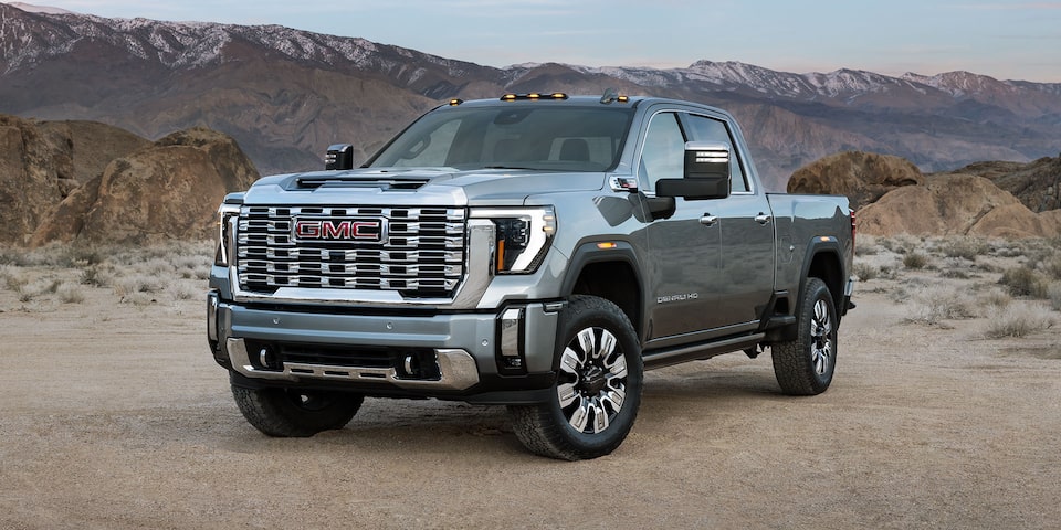 Front-side view of the 2025 GMC Sierra HD Denali Truck in the Desert.