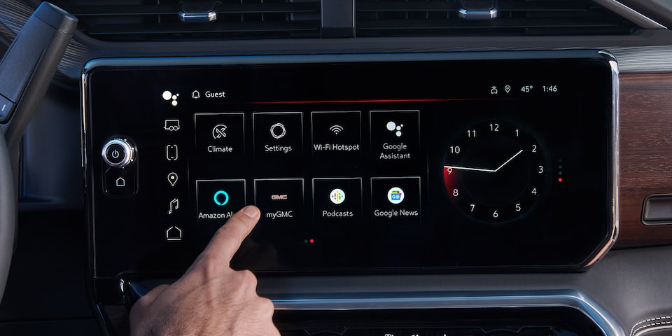 Close-up View of a person pressing the Infotainment Screen on the 2025 GMC Sierra HD Denali Truck.