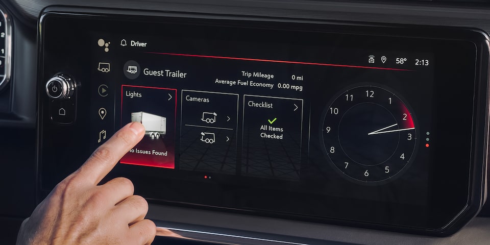 Close-up of a Driver Pressing a Feature Button on the Infotainment System