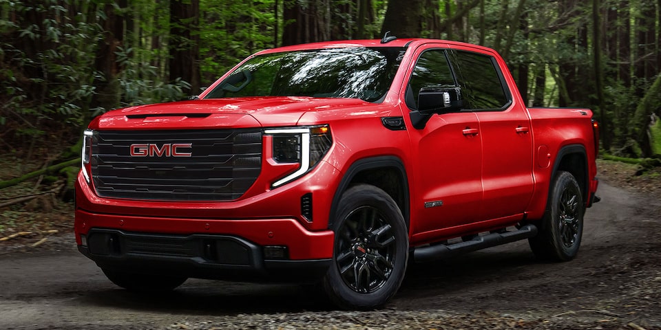 A Red GMC Sierra 1500 Pickup Truck Driving Off-Road