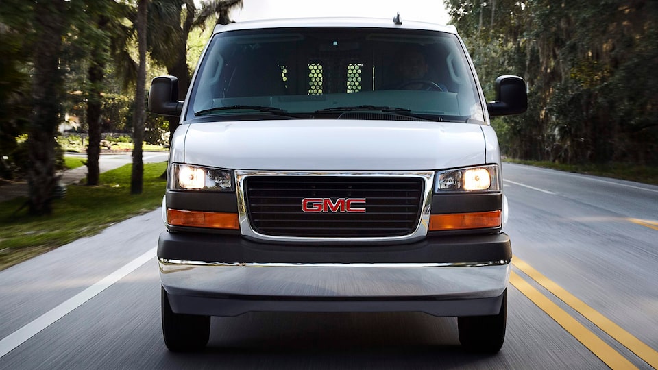 Front view of the 2024 Savana Cargo van driving down a highway.