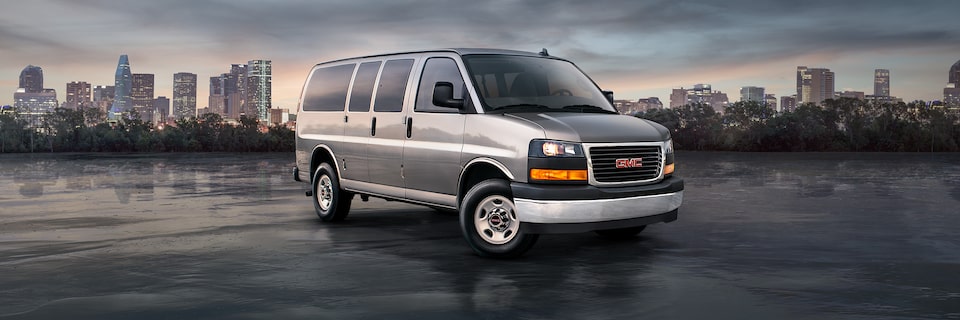 GMC Savana Passenger against a city skyline.