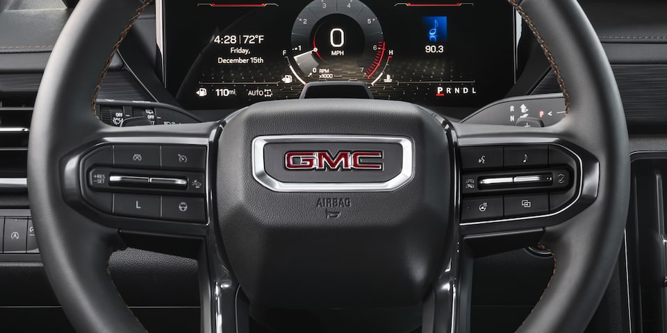 Close up view of the steering wheel on the 2025 GMC Acadia AT4.