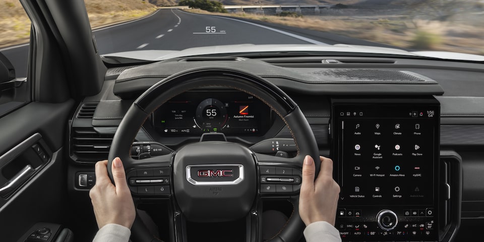 Driver's view of manning the steering wheel on the 2025 GMC Acadia AT4.