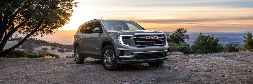 Front-side view of the 2025 GMC Acadia Elevation parked on a hilltop.