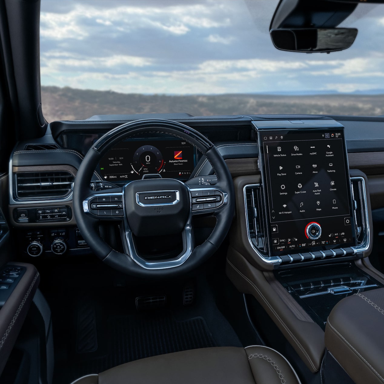 Interior View of the Steering Wheel and Infotainment Screen inside the GMC Yukon Large SUV.