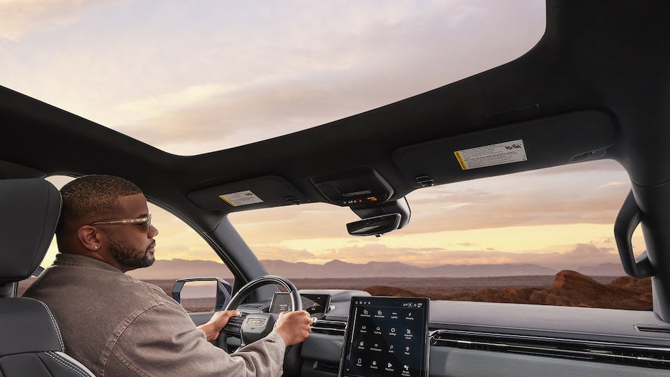 Rear Seat View of the 2026 GMC Sierra EV with the Panoramic Sunroof Open.