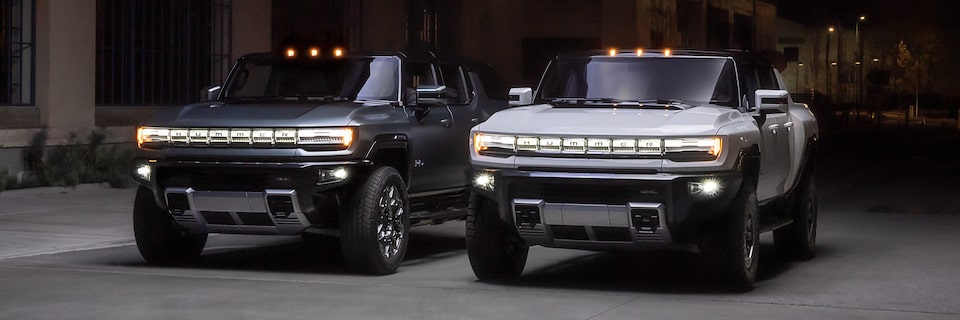 GMC HUMMER EV electric truck and electric SUV parked side by side.