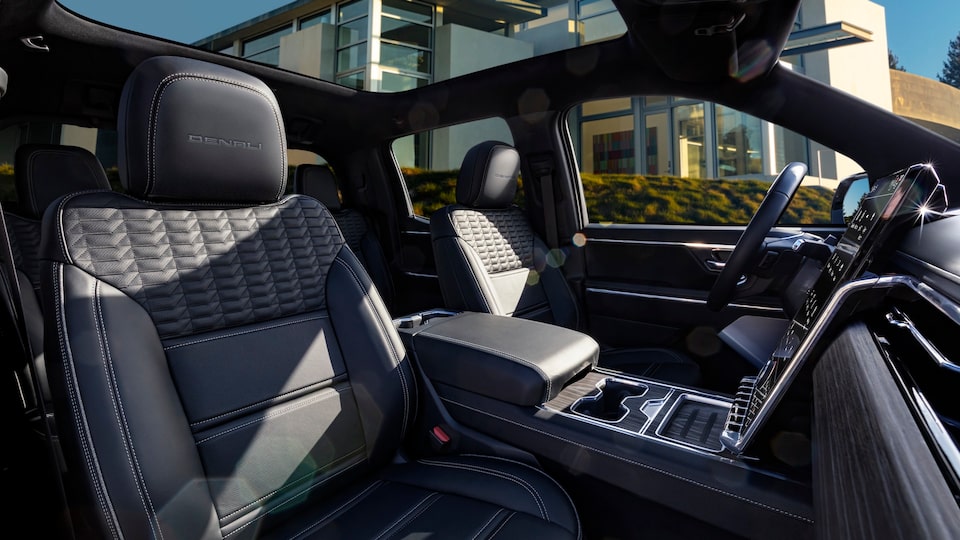 Side view of the front interiors of the 2025 GMC Sierra EV Denali.