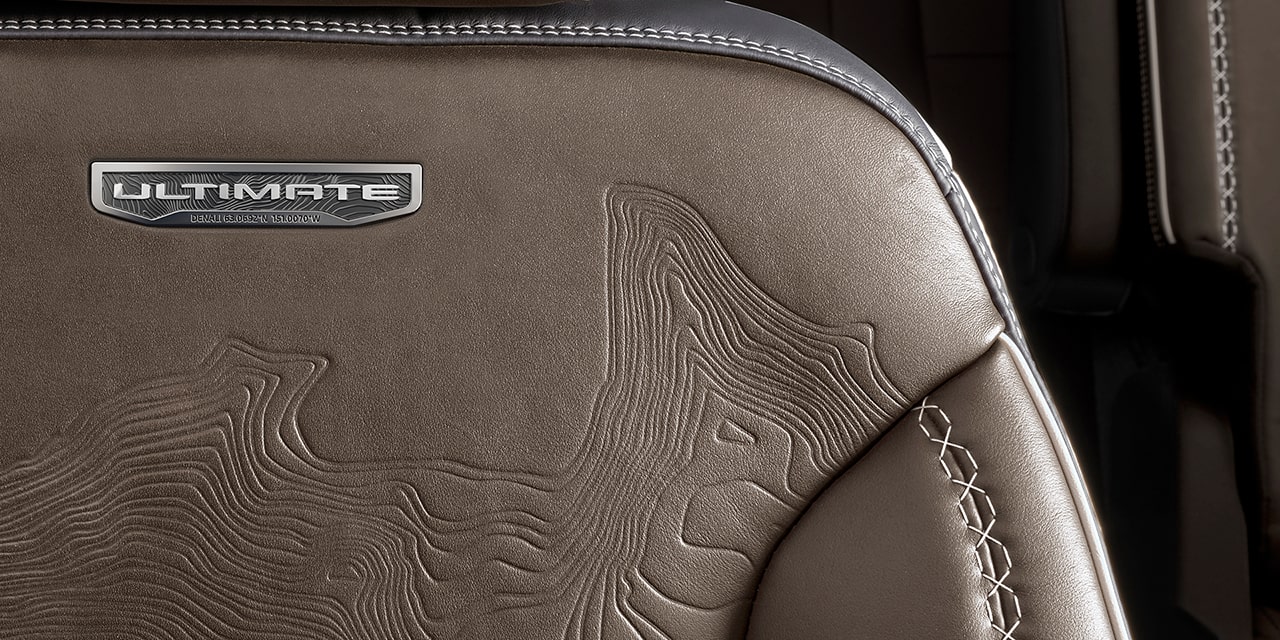 Close-up of the Ultimate Badging etched on the Leather Seats of the 2026 GMC Acadia Denali Ultimate.