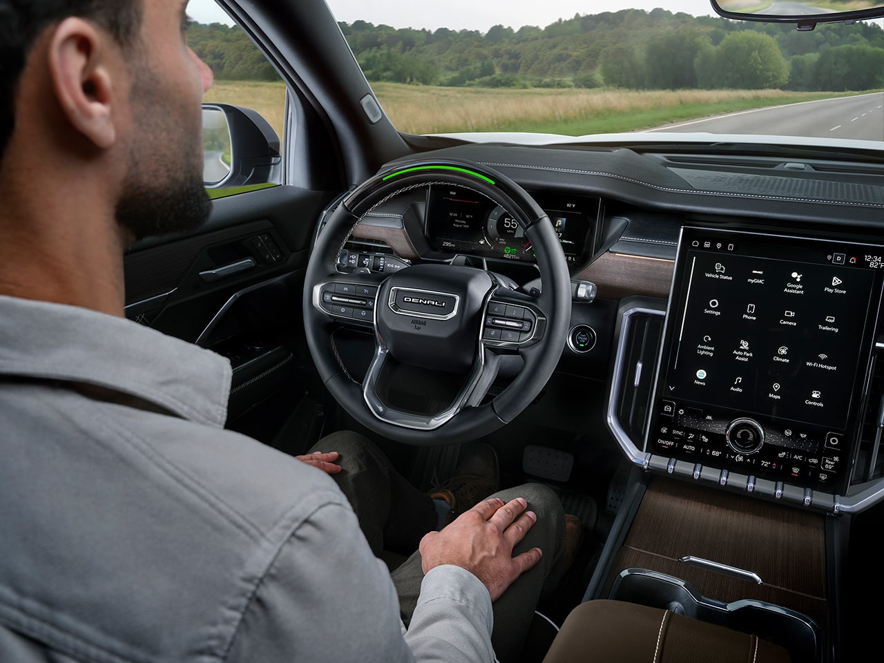 A person utilizing the Super Cruise Hands-Free Driving Technology of the 2026 GMC Acadia Denali Ultimate.