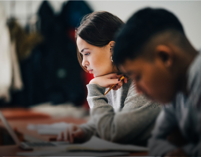 Two people concentrating on their tasks eligible for GM's Student Bonus Program.