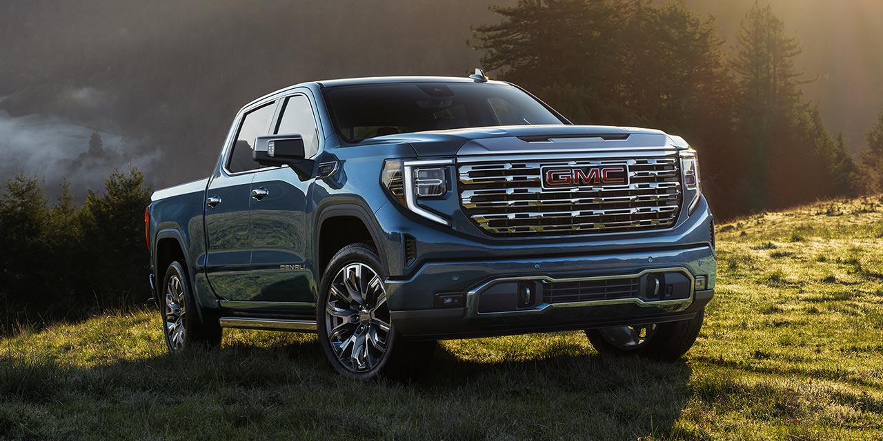 The GMC Sierra 1500 Full-Size Truck parked alone in a green valley.