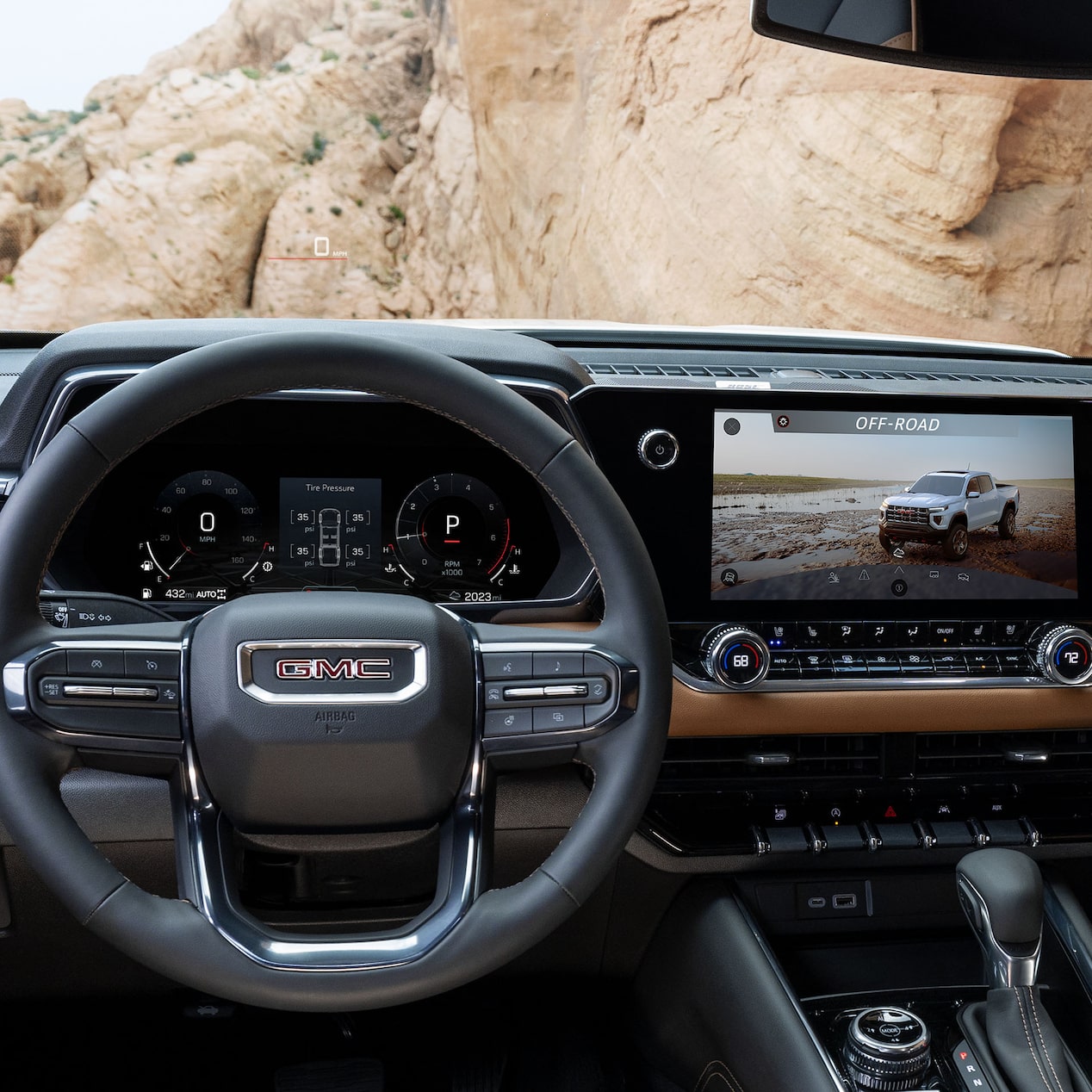 Front view of the interiors of the 2024 Canyon overlooking a cliff.