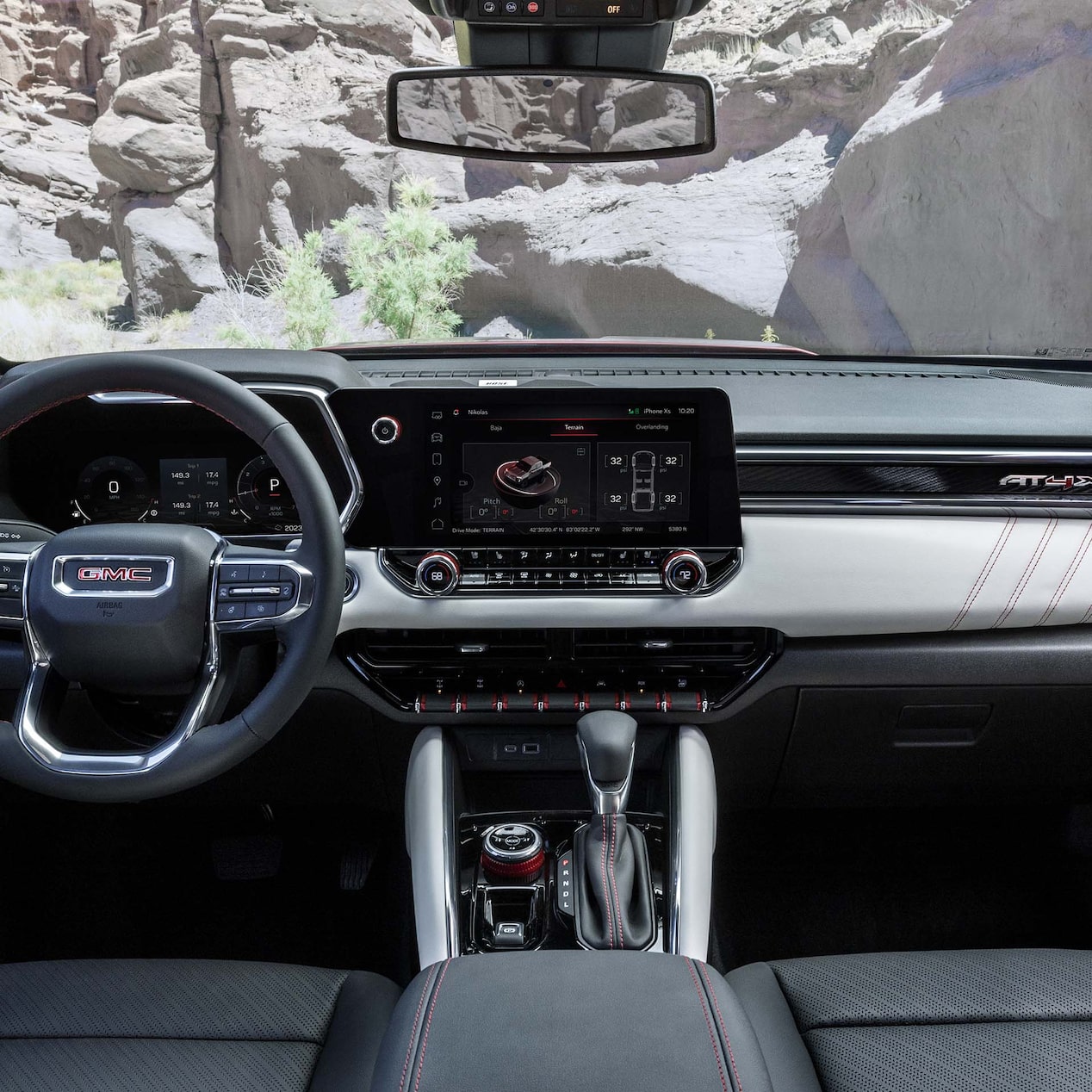 Front view of the interiors of the 2024 GMC Canyon overlooking a cliff.