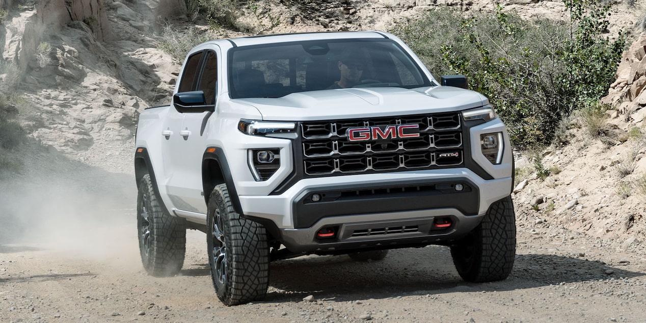 2024 GMC Canyon driving alone on a hillside road.