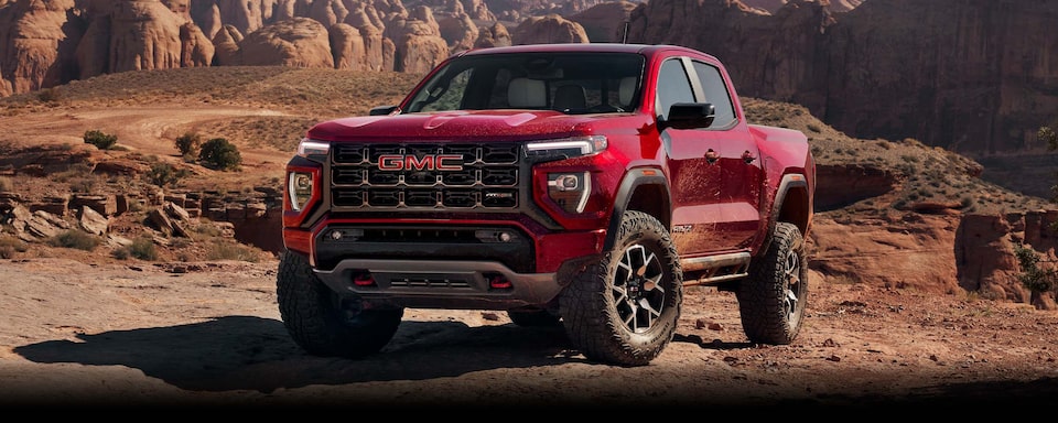 2024 GMC Canyon parked fiercely on top of a rocky canyon.