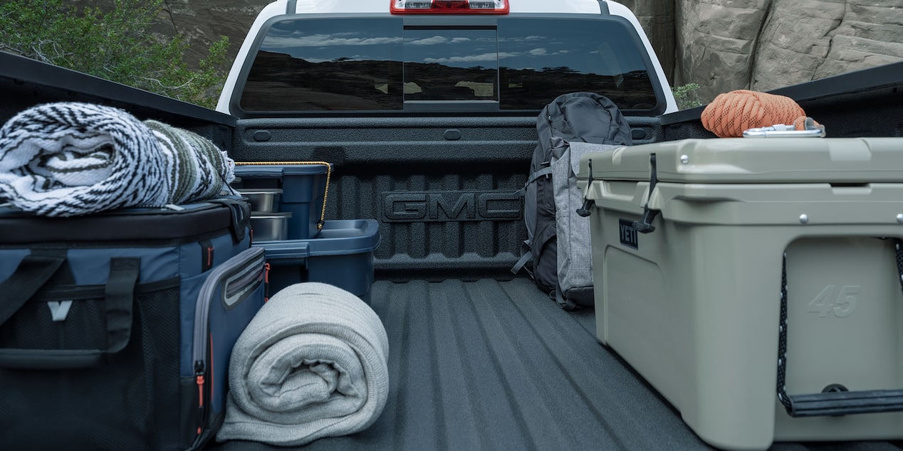 Camping equipment stored on the cargo bed of the 2024 Canyon.