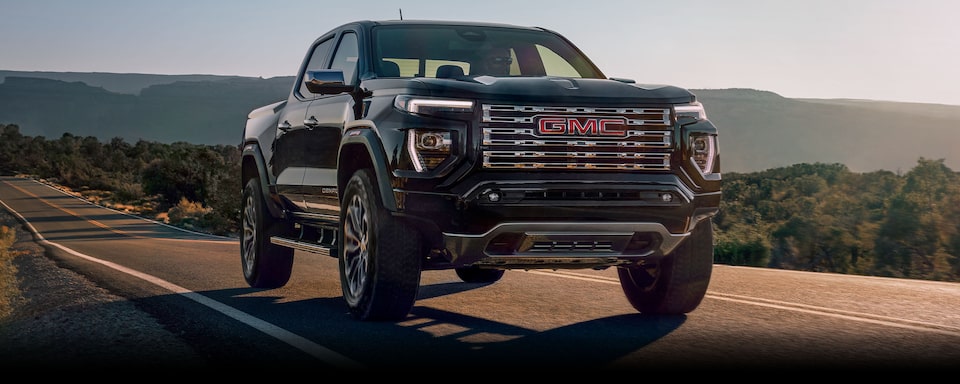 2024 GMC Canyon driving alone on a mountain road.