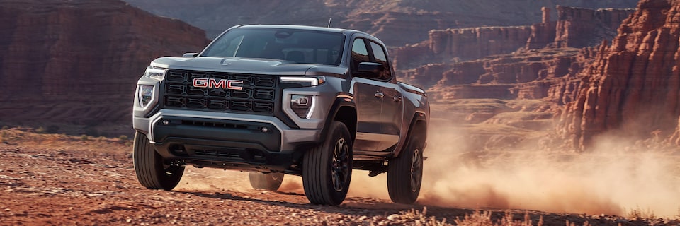 2025 GMC Canyon skidding on a dusty terrain.