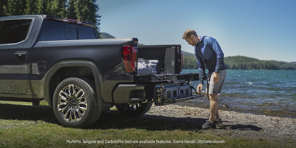 Un homme utilise le hayon MultiPro du pick-up GMC Sierra 1500.