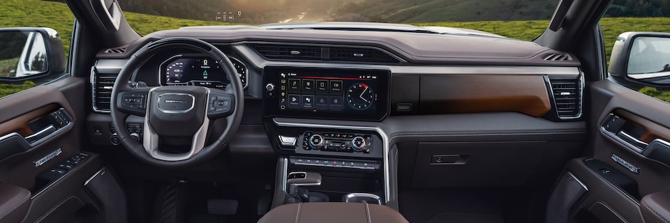 Interior View of the GMC Sierra 1500 Pickup Truck's Steering Wheel, Infotainment System, and Dashboard