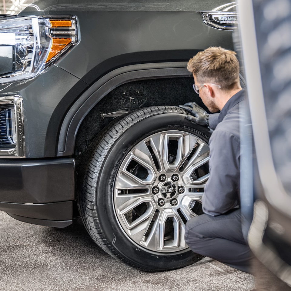 Close-up of a Mechanic Working on a GMC Truck