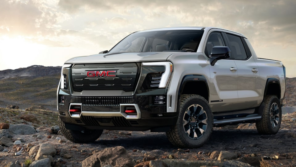 A Stunning View of the GMC Sierra EV Denali Parked Off-Road With a Sunset